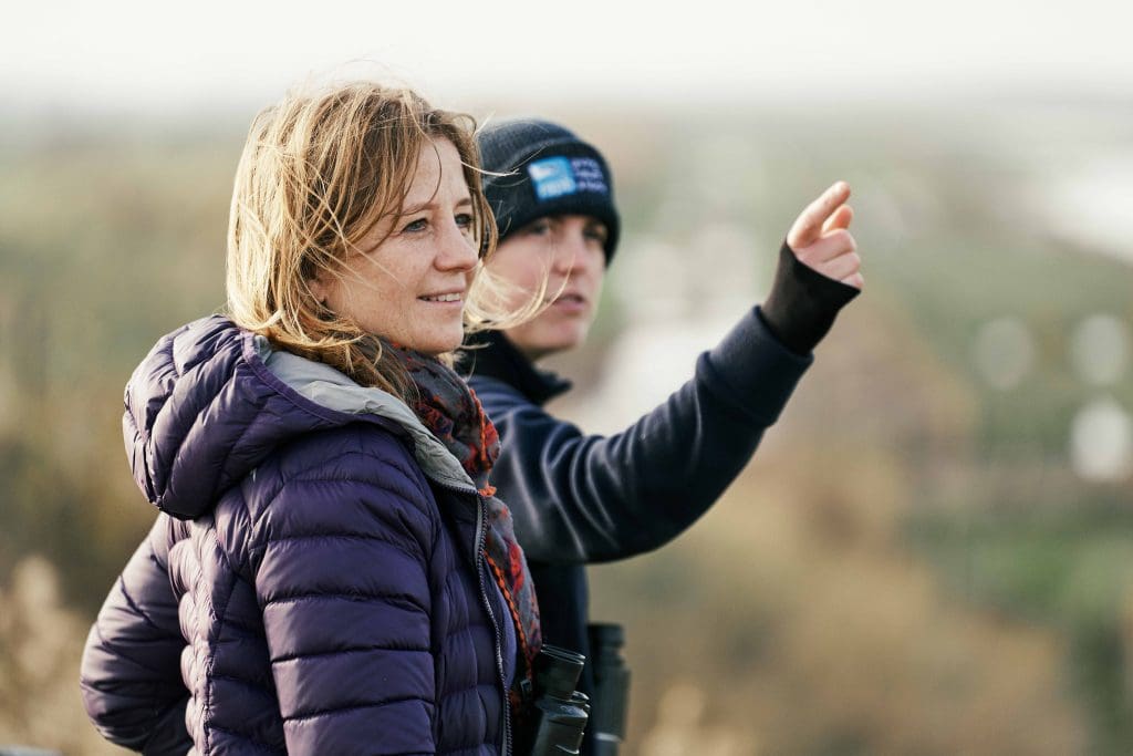 Two bird watchers, one pointing