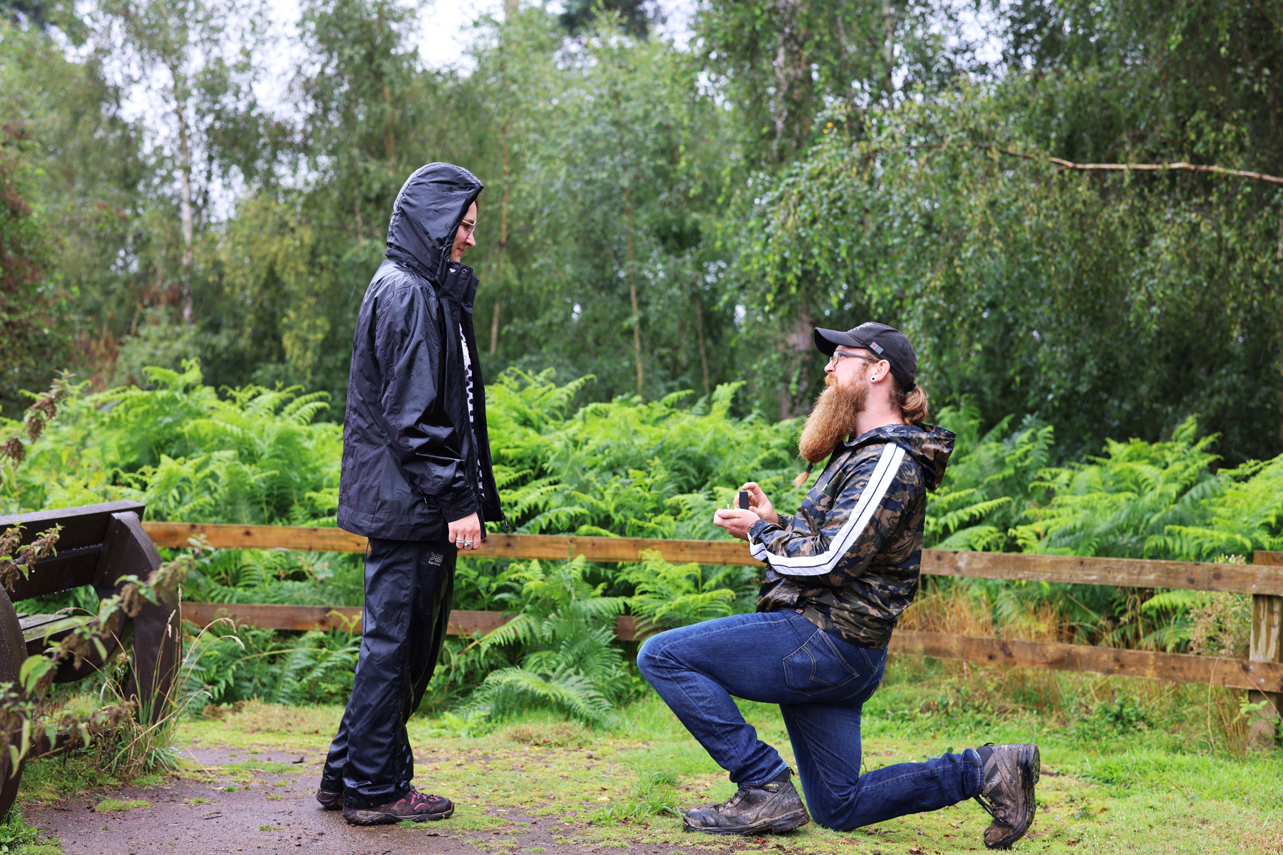 Kneeling man proposing to woman outside