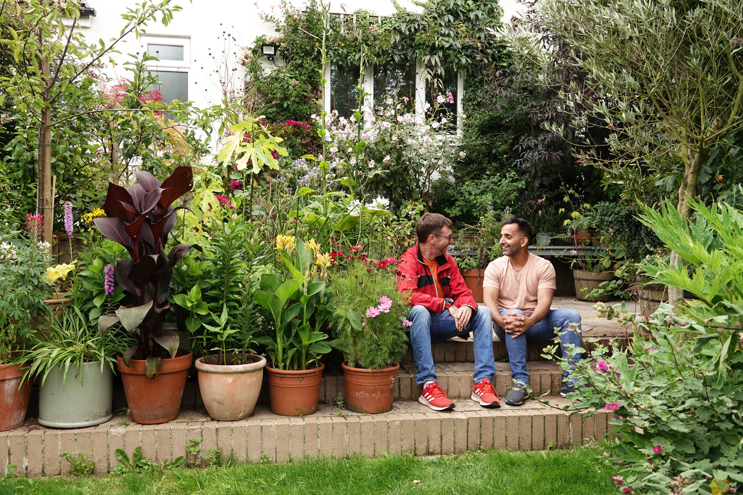 Dr Amir Khan in his garden with Adrian Thomas