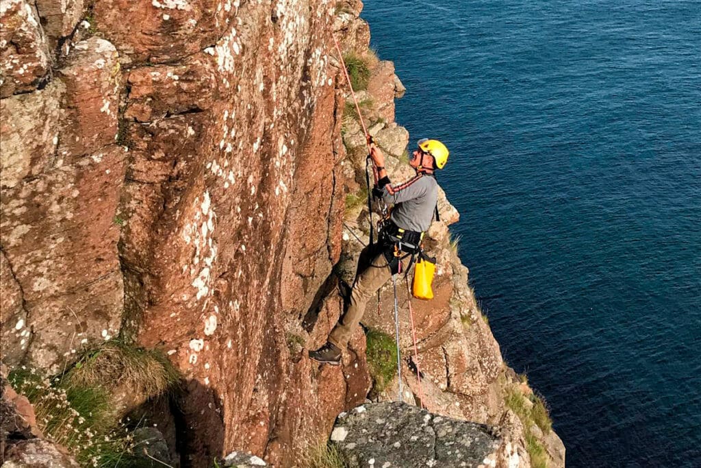 Climbers searching for ferrets on Rathlin Island.