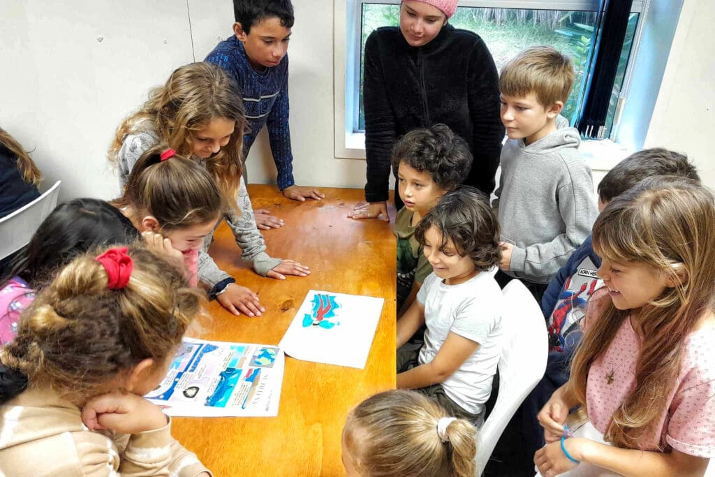 Schoolchildren working around desk