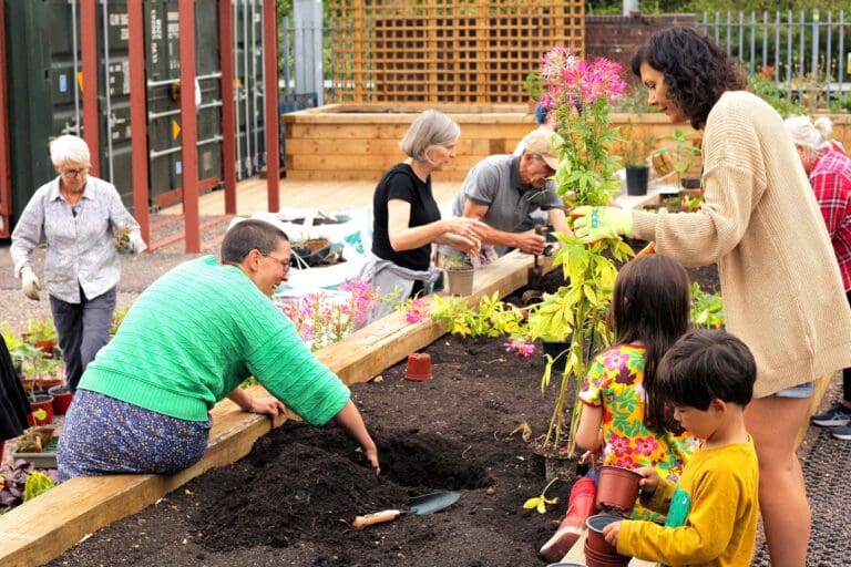 Volunteer gardeners plant a wildflower bed