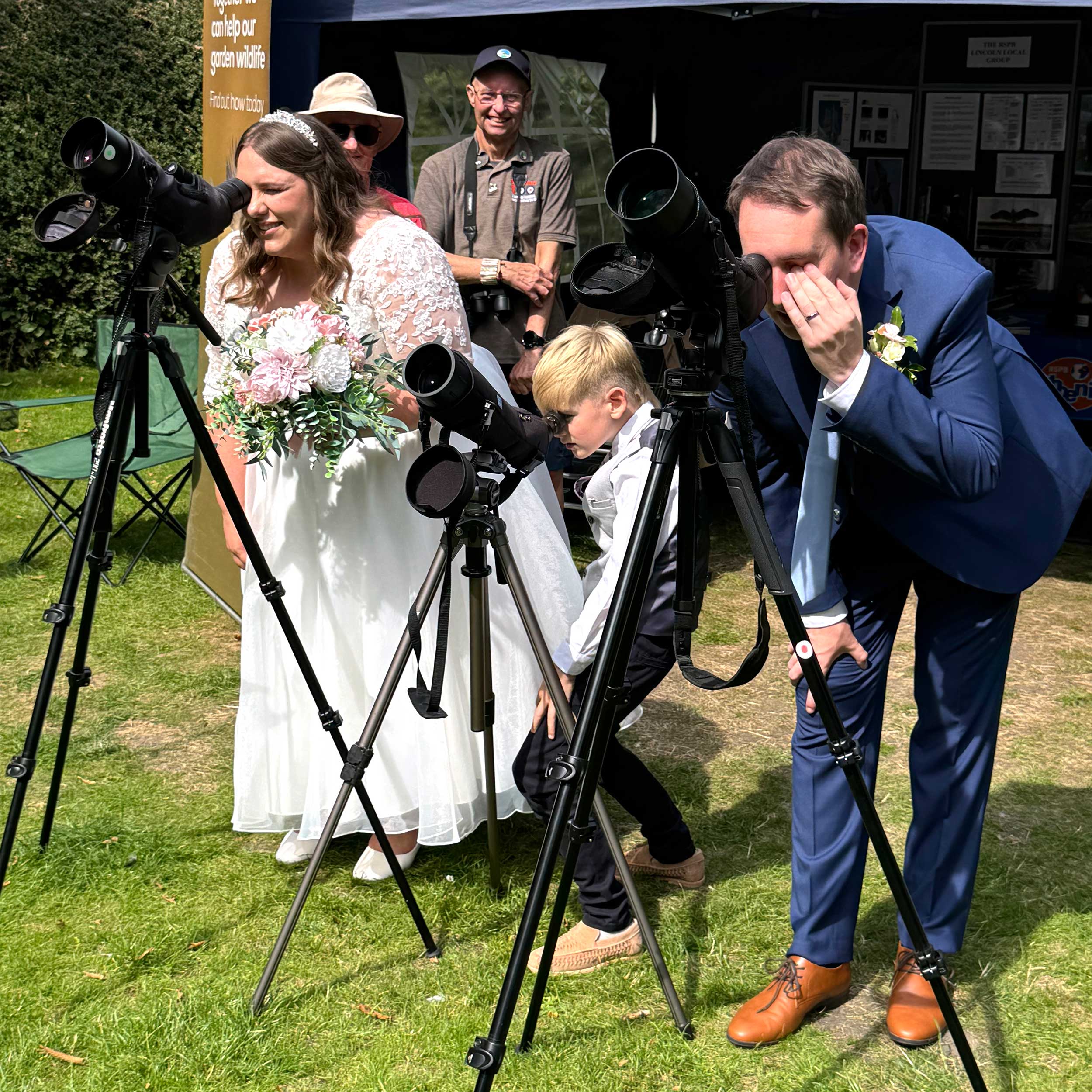 Newlyweds Amy and Nathan Chudley admiring Peregrines after their wedding at Lincoln Cathedral.