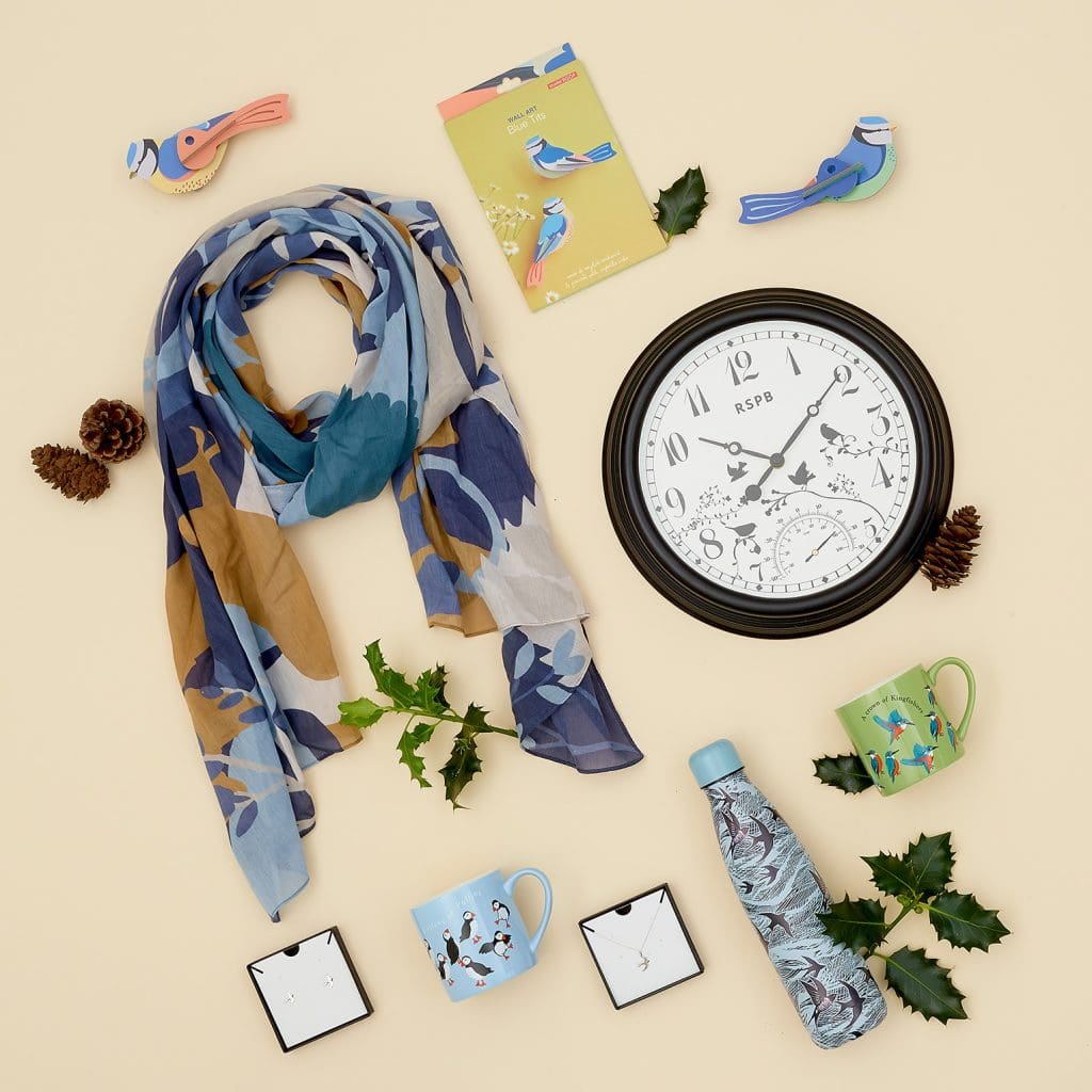 A range of festive gifts for bird lovers including a clock, scarf and water bottle.