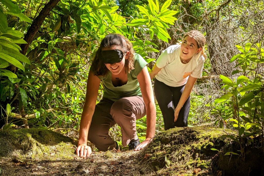 Two students smiling as they enjoy an outdoor activity.