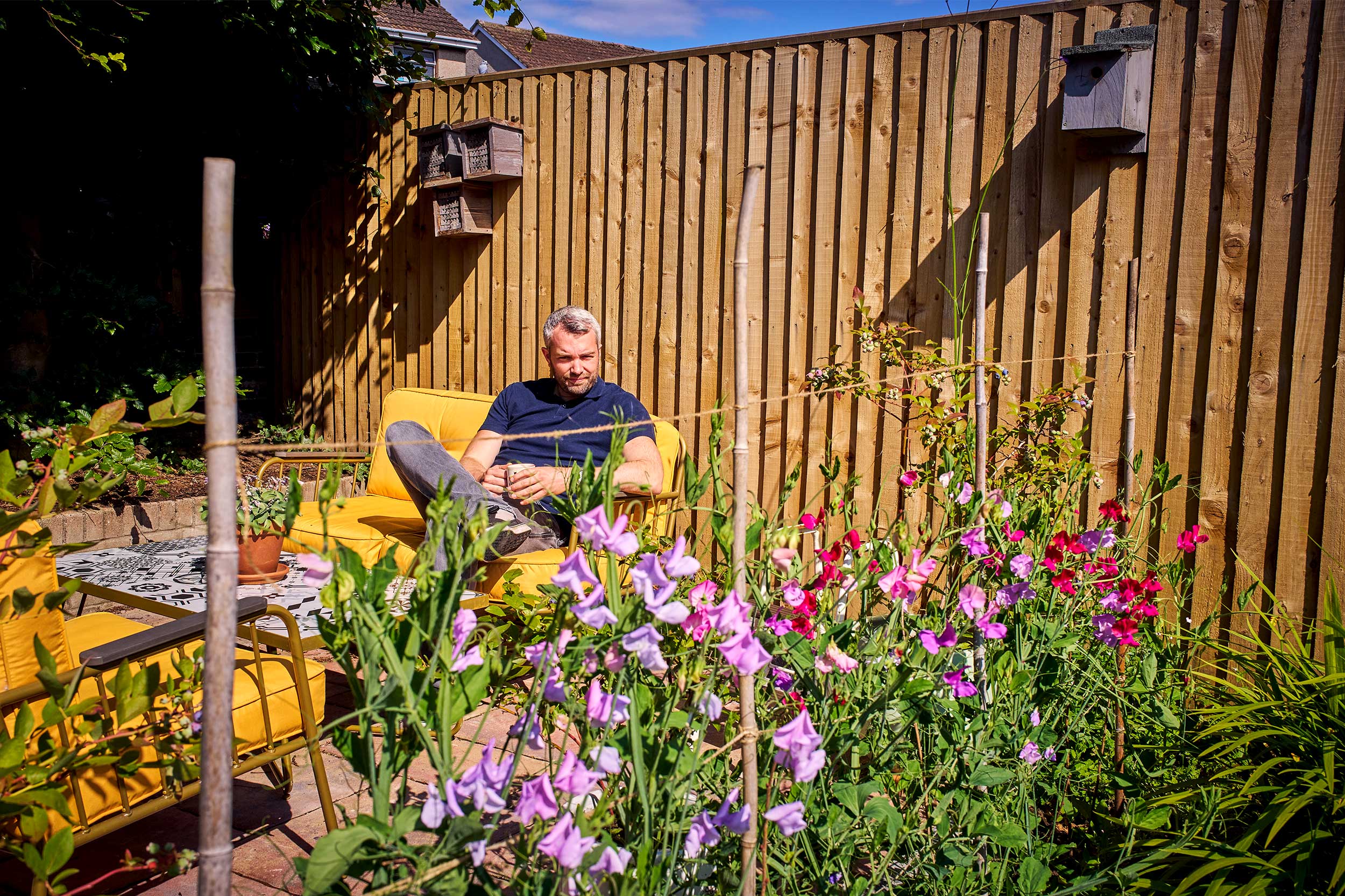 James sits in his wildlife garden