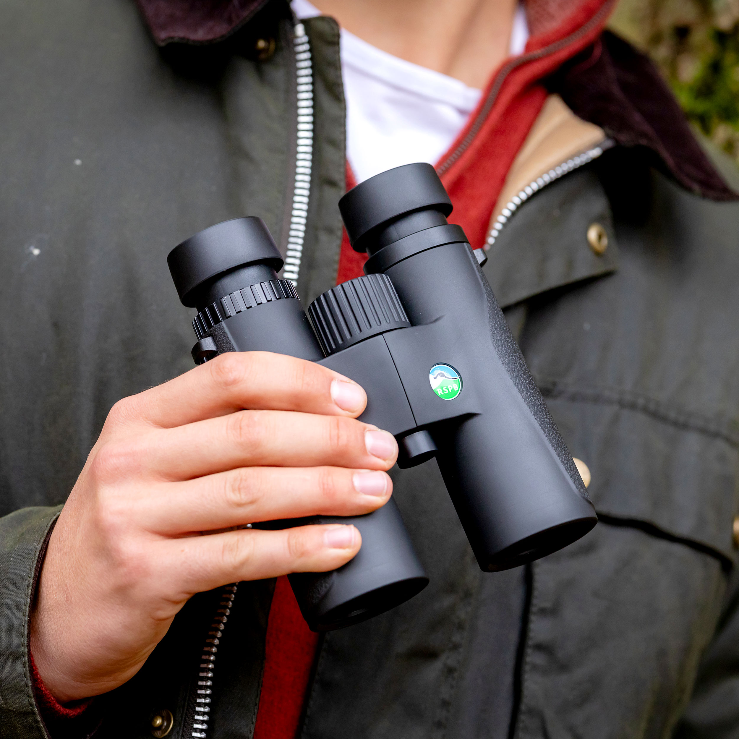 RSPB Skylark binoculars held in someone's hand