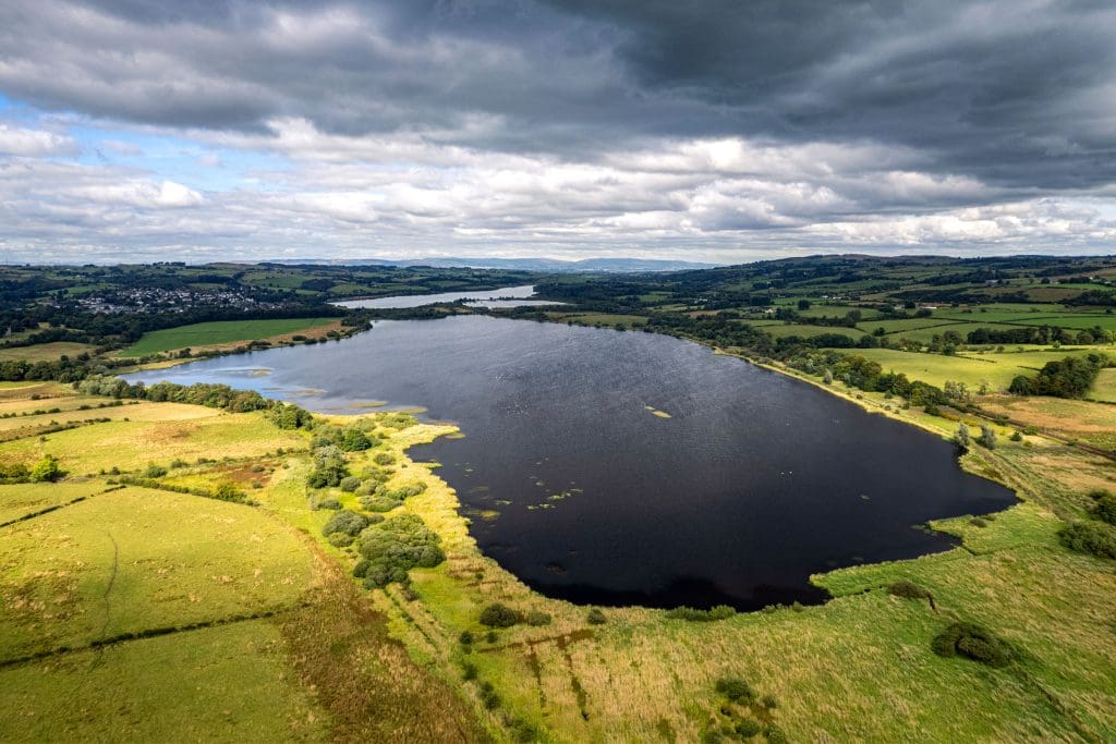 An aerial shot of three lochs surrounded by fields