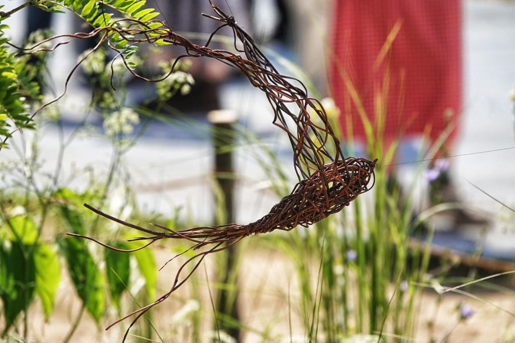 A woven metal sculpture of a Swift