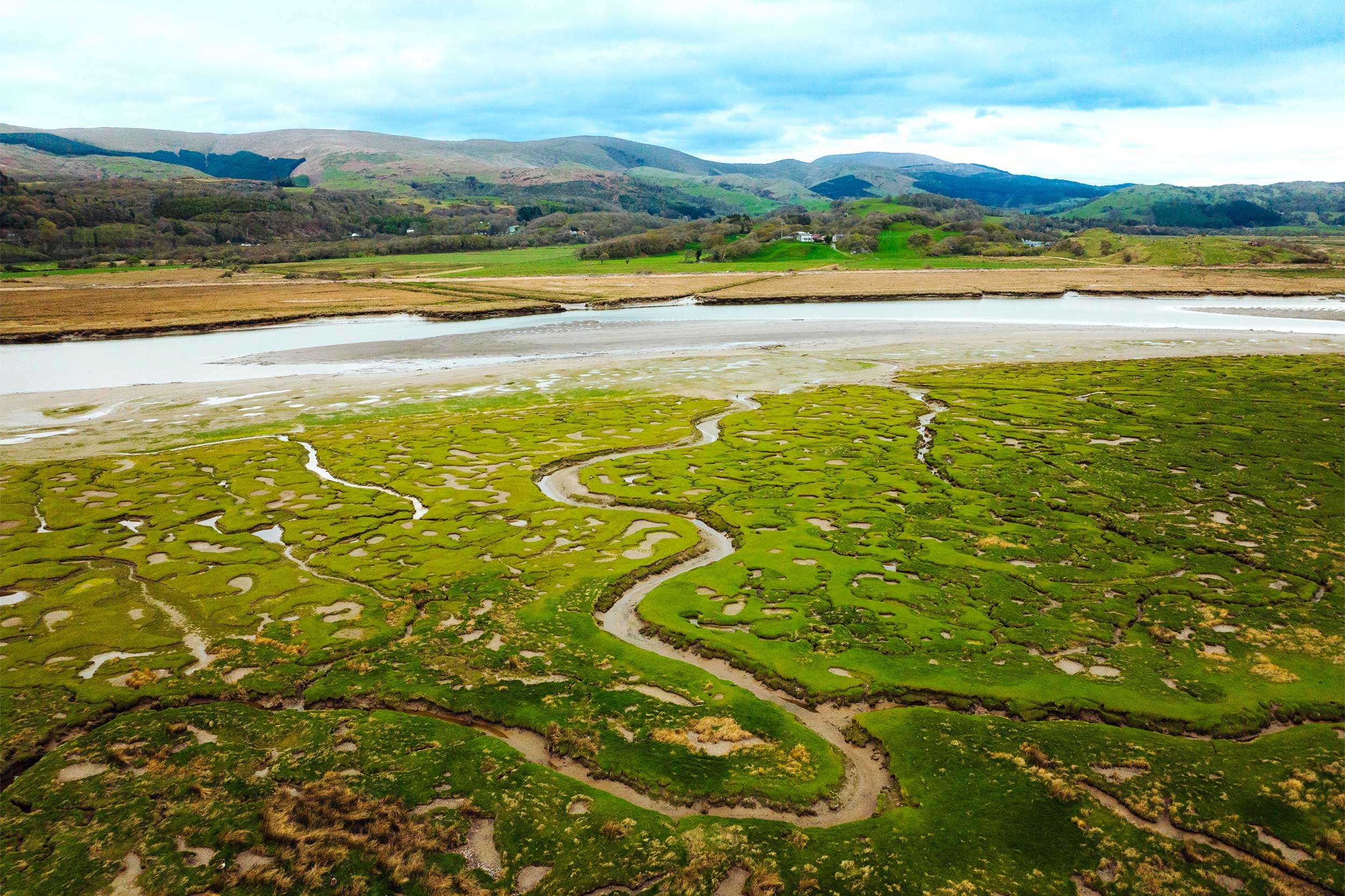 Guided-tour_2222980-Nathan-Lowe-(rspb-images.com)-HR An aerial view of RSPB Ynis-Hir shows the estuary with mountains in the background