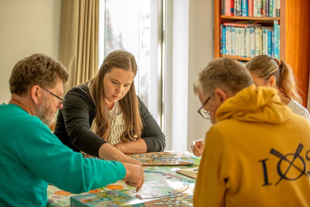 A group of friends build an RSPB jigsaw puzzle