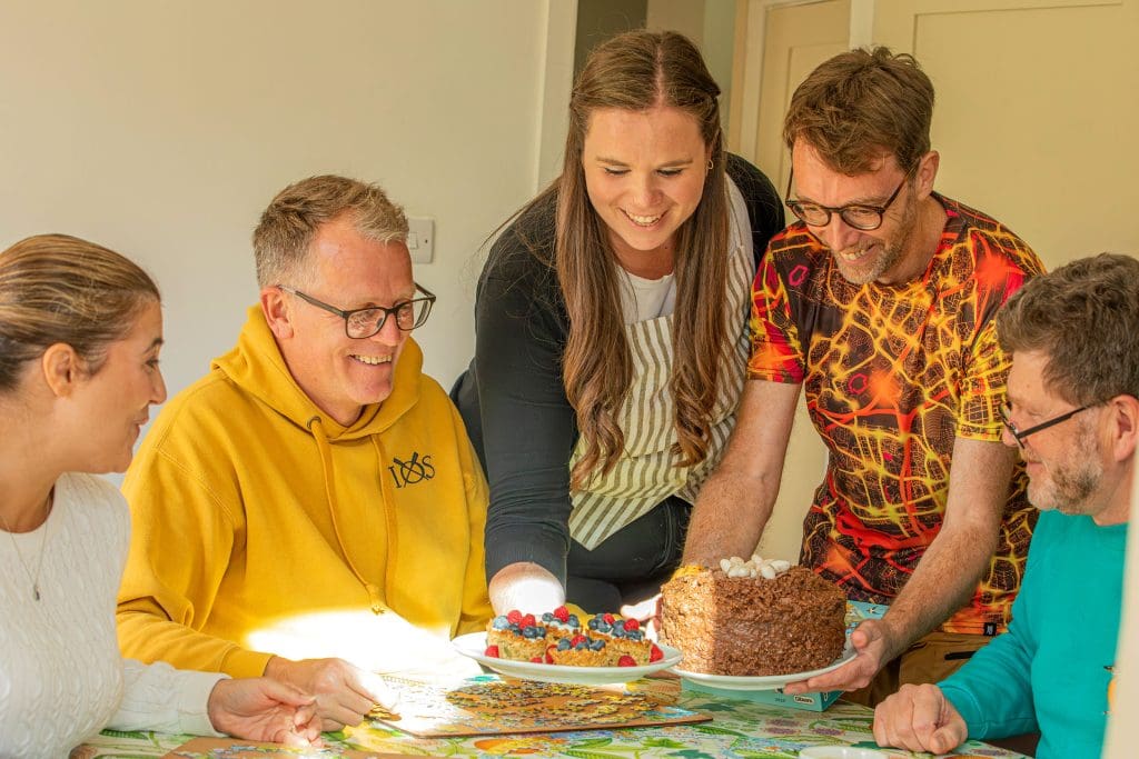 A group of friends share bird themed cakes
