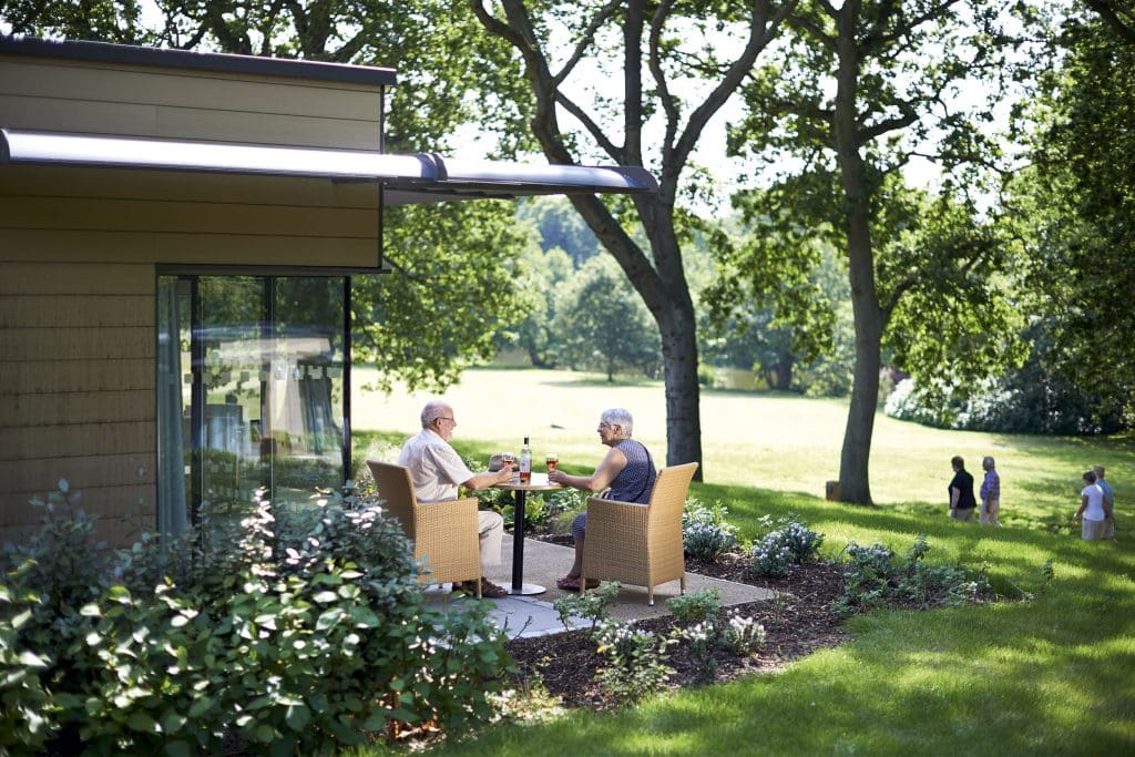 People sit outside at Gunton Hall