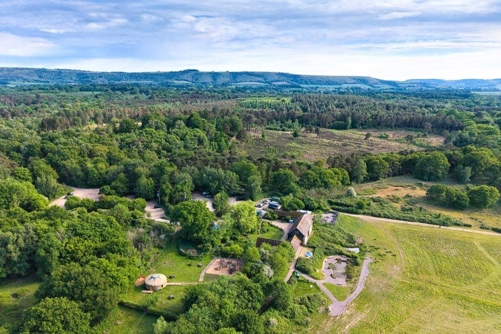 An aerial shot of Pulborough Brooks, showing areas of woodland and a building and car park