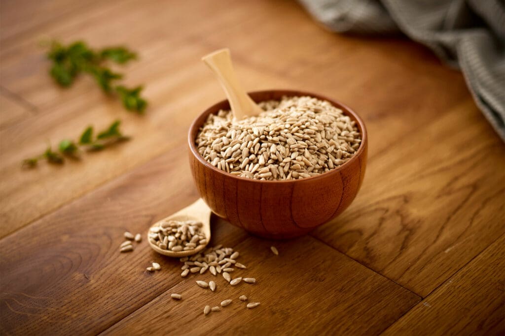 Bowl of seeds on a wooden table