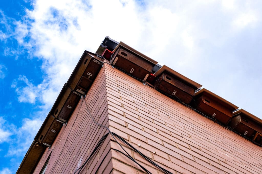 Seven Swift boxes installed under the eaves of a house