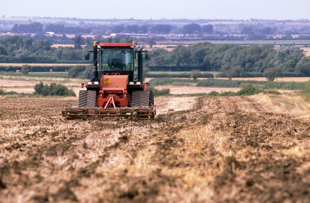A tractor preparing ground in summer