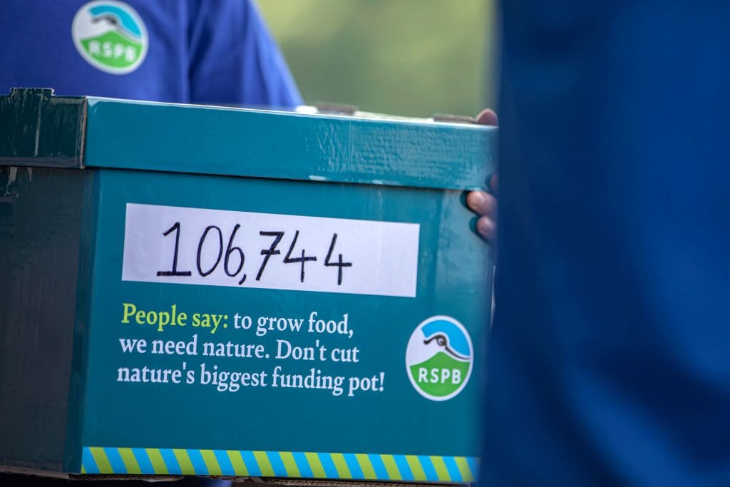 A box reads '106,744 people say: to grow food, we need nature. Don't cut nature's biggest funding pot!'