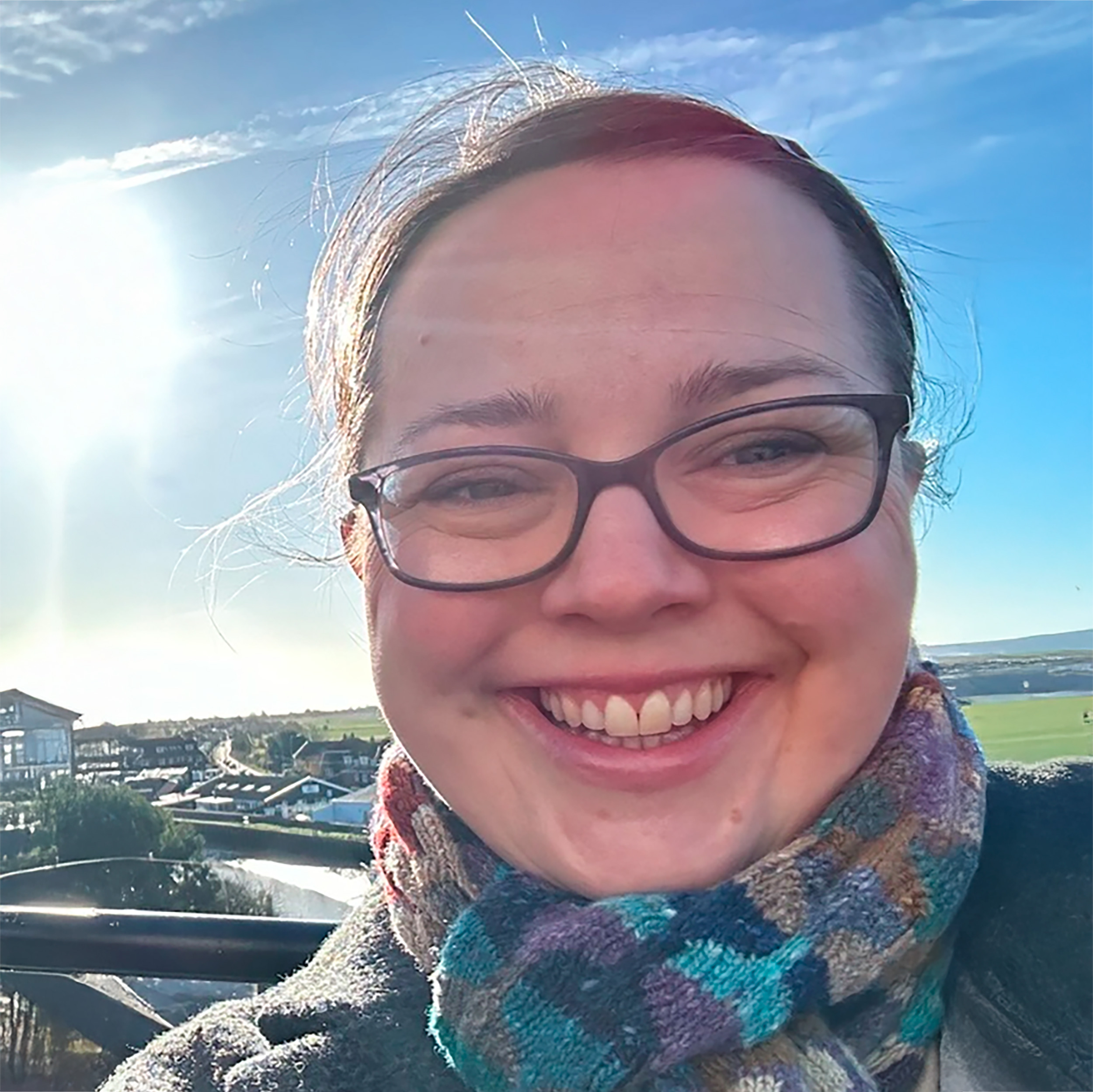 A selfie of Alice Hardiman, she is stood outside smiling at the camera