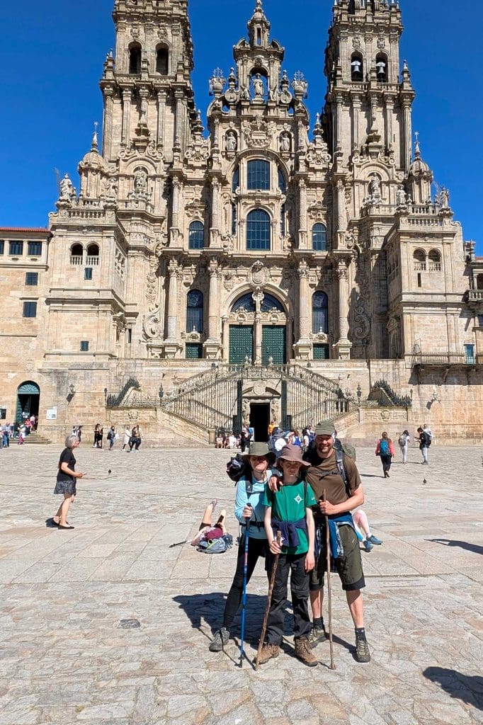 A family are stood outside a grand cathedral in Spain