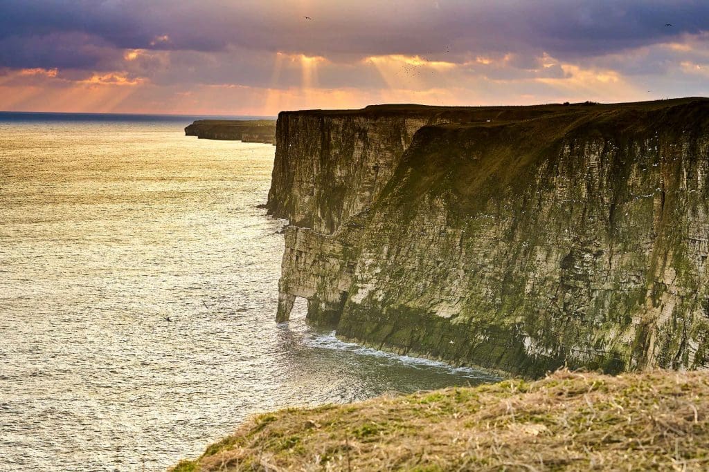 Cliffs with the sun breaking through the clouds at Bempton Cliffs