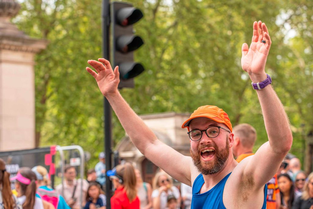 IMAGE.Carl-Hall-raising-money-for-the-RSPB-by-running-the-London-Marathon.RSPB_1004318.Credt-BenAndrew Carl Hall turns to look at the camera, mouth wide with cheer and arms in the air