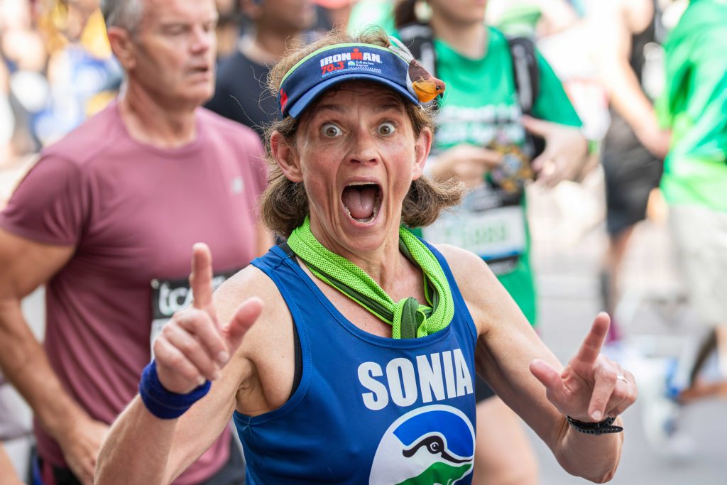 IMAGE.RSPB_1005285.Sonia-Harris-running-the-London-Marathon.Credit-BenAndrew Sonia Harris runs past with an amazed expression, pointing her first fingers upwards