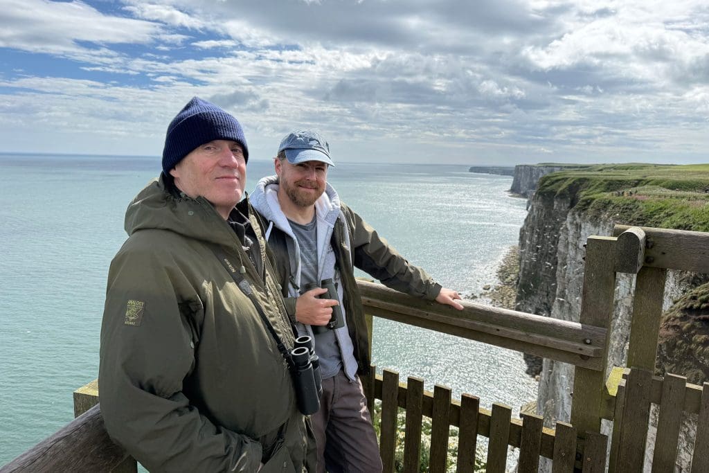 IMG_2088 Adrian and Sam stand on a viewpoint overlooking cliffs and the sea