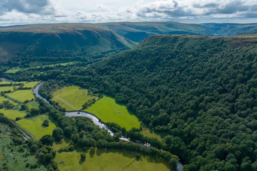 Gallt-y-bere.credit-Nick-Rodd An aerial shot showing woodland, a river and hills